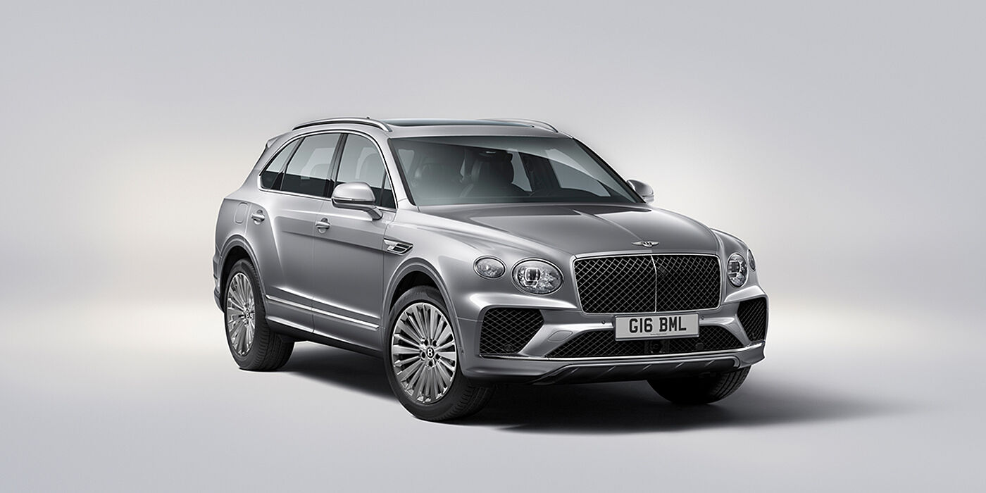 Bentley Surrey Bentley Bentayga luxury SUV front three quarter view in Moonbeam paint with matrix grille and 21″ 5 spoke painted wheels