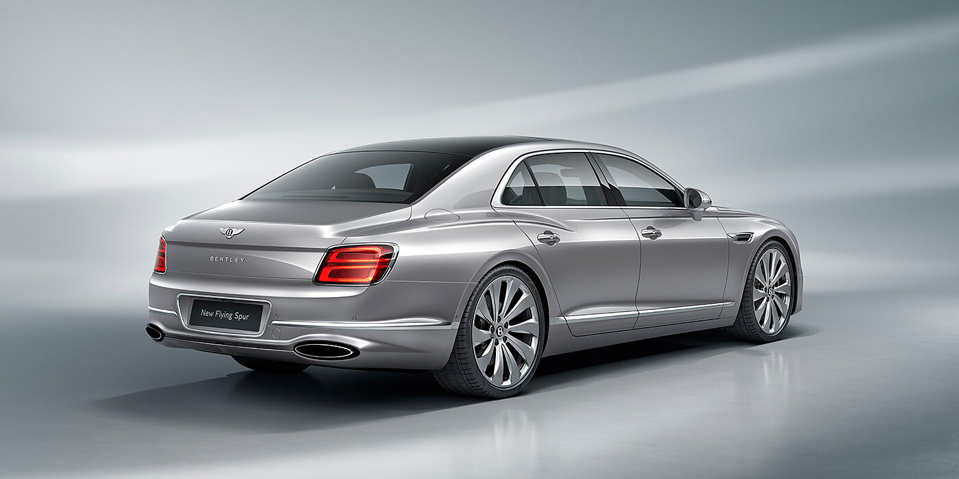 Bentley Surrey New Bentley Flying Spur sedan rear view in Silverlake paint with ten spoke wheels and chrome matrix grille