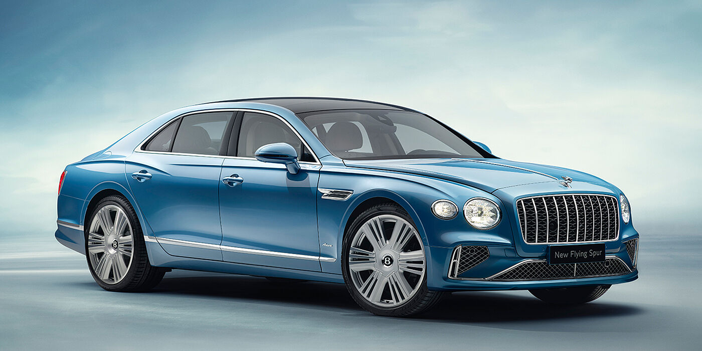 Bentley Surrey New Bentley Flying Spur Azure sedan front view in Light windsor blue by Mulliner paint with 22 inch Azure wheels and chrome exterior details