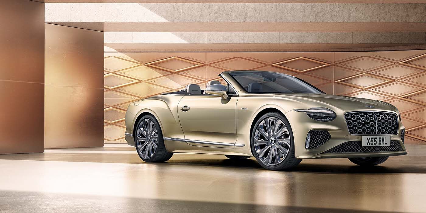 Bentley Surrey Bentley New Continental GTC Mulliner V8 hybrid front three quarters in Patina paint