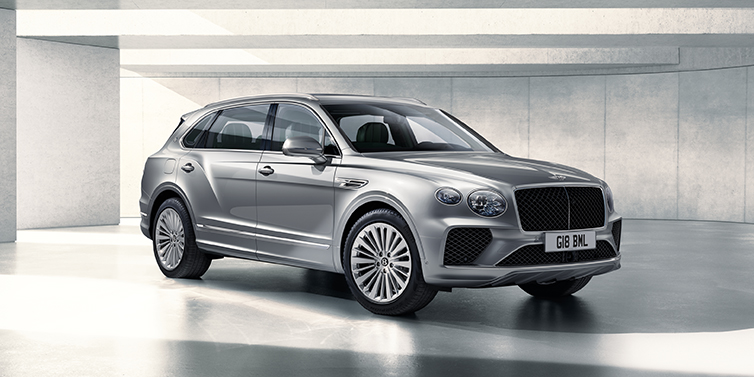 Bentley Surrey Bentley Bentayga Extended Wheelbase SUV front three quarter in Moonbeam paint with a grey background
