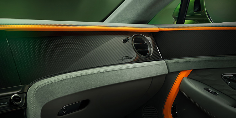 Bentley Surrey Bentley Continental GT Speed coupe front interior dash detail with high gloss carbon fibre veneer surrounded by Mandarin by Mulliner and Gravity Grey hides