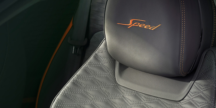 Bentley Surrey Bentley Continental GT Speed coupe seat detail in Gravity Grey hide and Speed emblem in Mandarin by Mulliner coloured embroidery