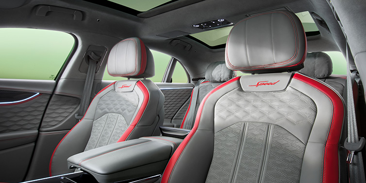 Bentley Surrey Bentley Flying Spur Speed sedan interior showing front and rear seats in Hotspur red and Gravity Grey hides, with Speed seat emblems