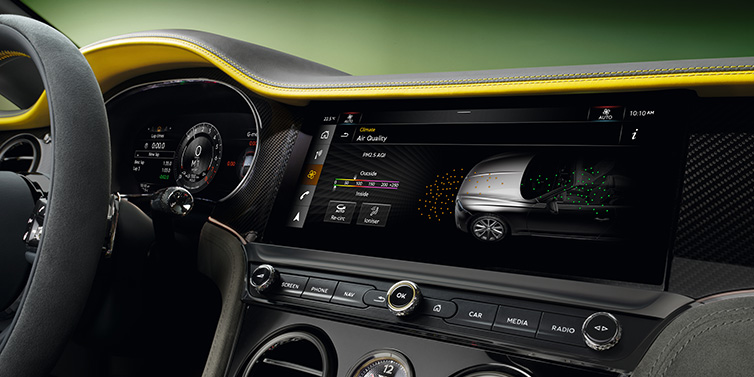 Bentley Surrey Bentley Continental GTC Speed convertible front interior centre console with MMI screen showing Air Quality visualisation surrounded by Cyber Yellow by Mulliner and Gravity Grey hides and high gloss carbon fibre veneer