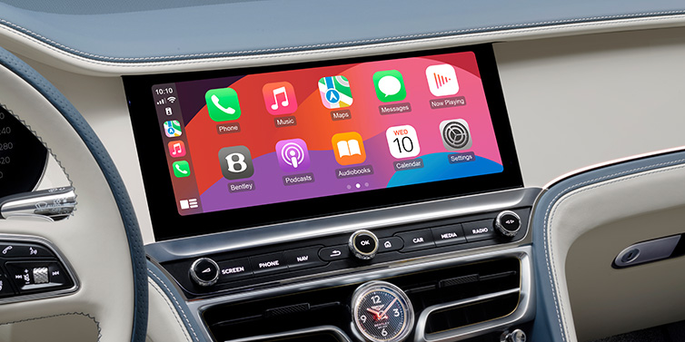 Bentley Surrey New Bentley Flying Spur Azure sedan front cabin central MMI screen showing available services against Linen and Brunel hides and Piano Linen veneer