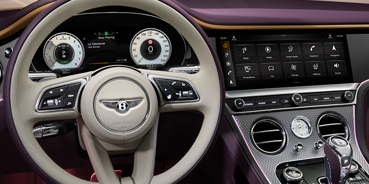 Bentley Surrey Bentley Continental GTC Mulliner convertible steering wheel and drivers screens surrounded by Damson purple and Linen hides